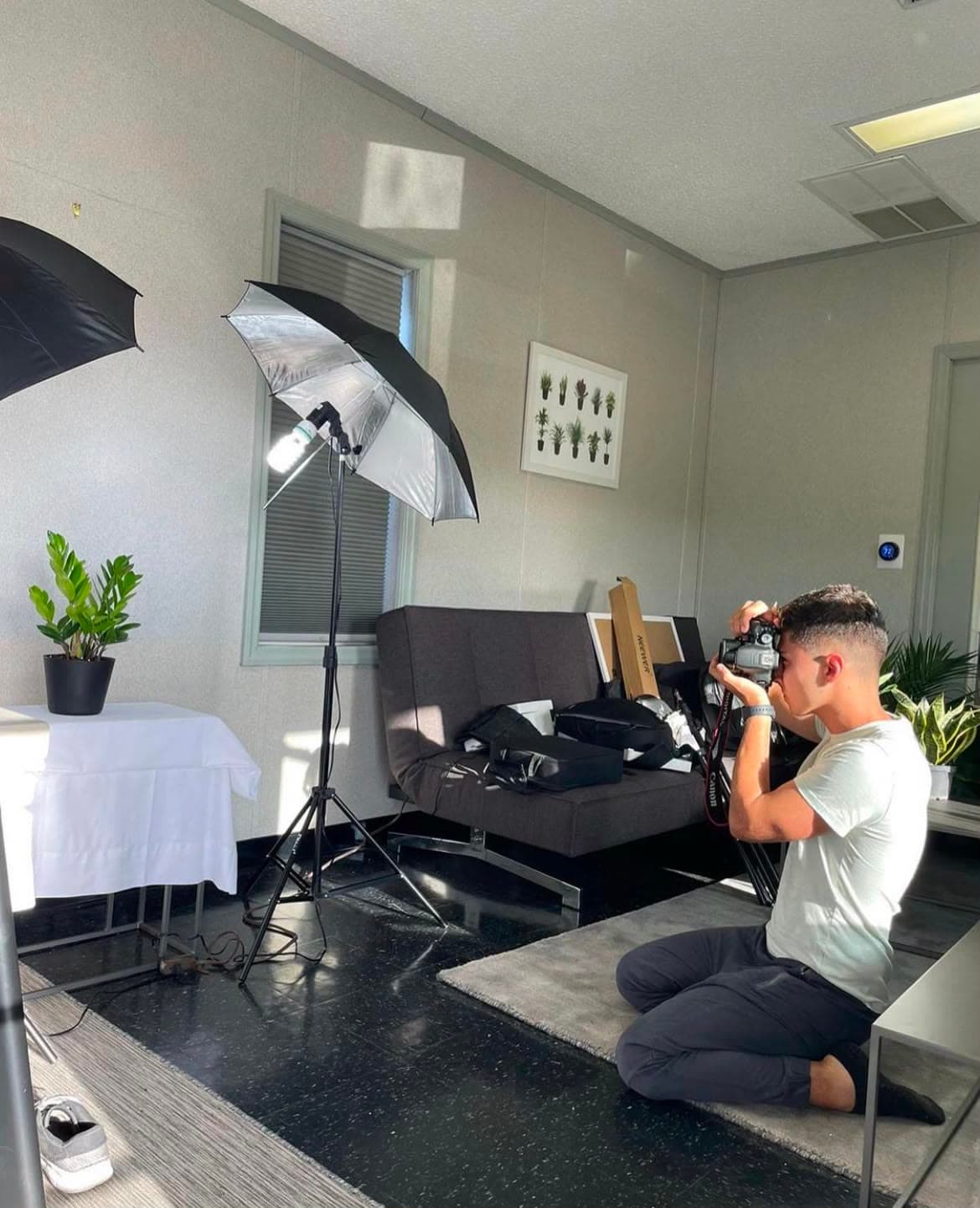Esteban Moreno filming with a Canon camera on a lit studio set in Fort Lauderdale